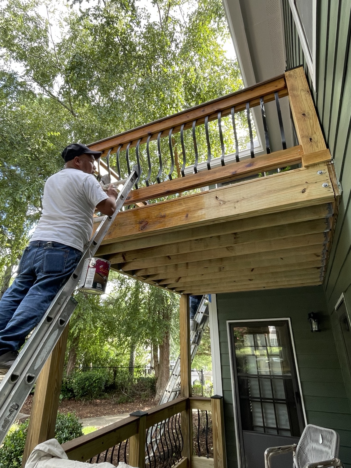 Deck staining with modern railings