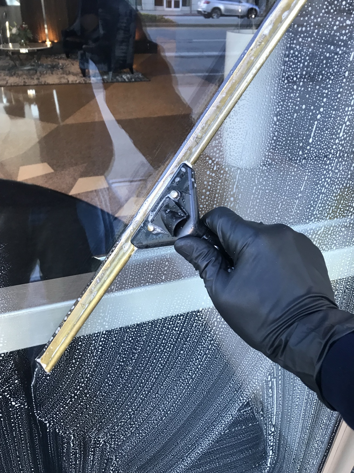 Professional squeegee technique for streak-free window cleaning